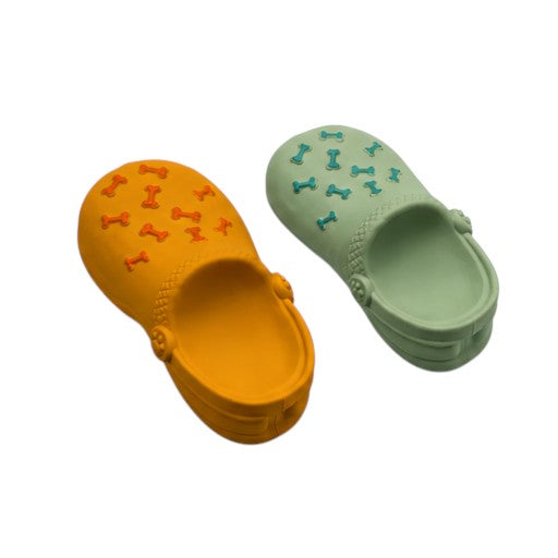 Joopy & Co squeaky slipper dog toys in orange and sage green silicone with bone-shaped embossed details